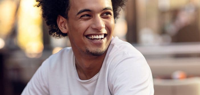 Close up portrait of handsome cheerful african man smiling looking at camera