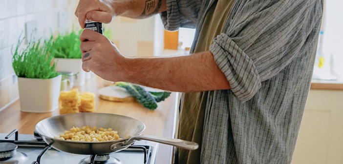 man cooking on gas stovetop