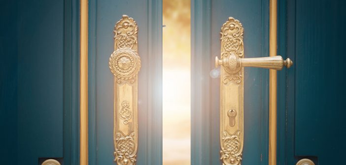 antique ornate gold door handle closeup on blue wooden door