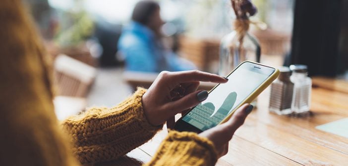 girl hold in hands yellow empty screen mobile phone close up, person type message on smartphone in sun cafe, relax tourist travels planning trip, hipster enjoy journey in cityscape, lifestyle holiday concept, internet online