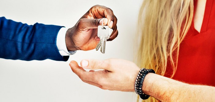 realtor hands keys to real estate investors