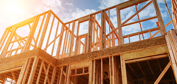 home framing during home construction against cloudy sky