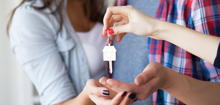 realtor giving house keys to homeowners