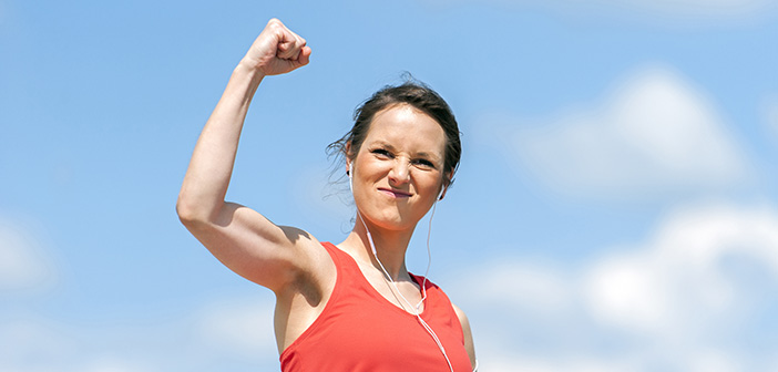 woman with victorious fist in air signifying accomplishment