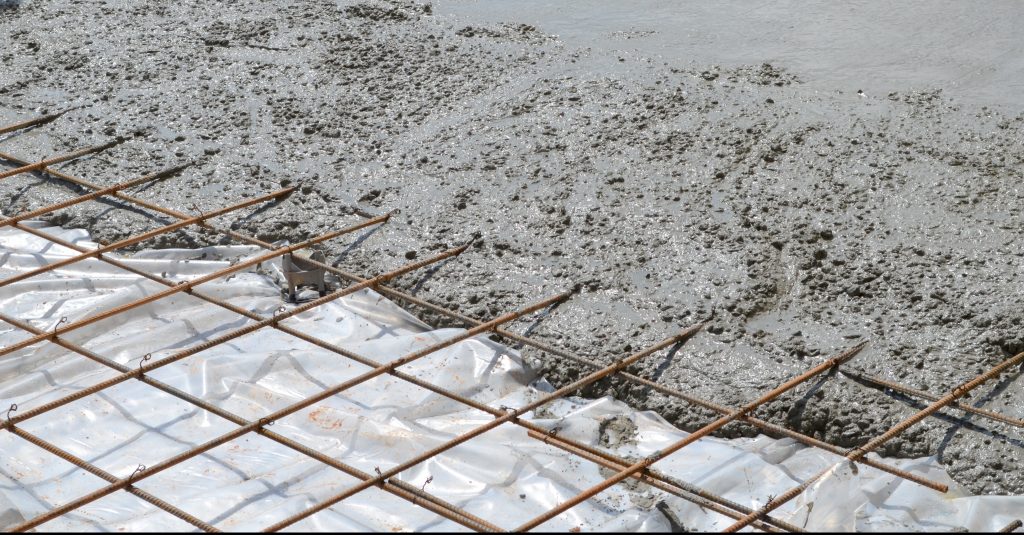 steel mesh grid with wet concrete poured on part