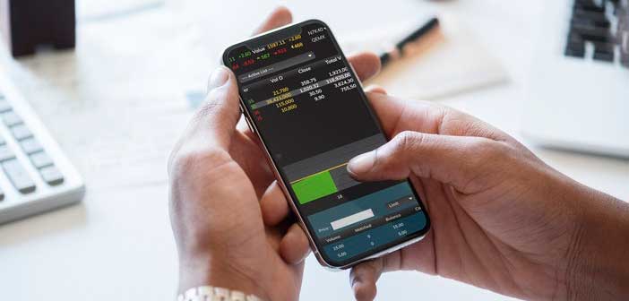 closeup of man holding smart phone checking stocks