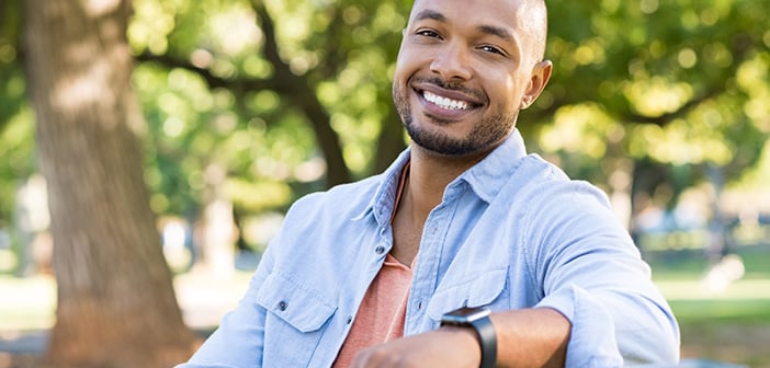 Young african man relaxing at park in a summer day.