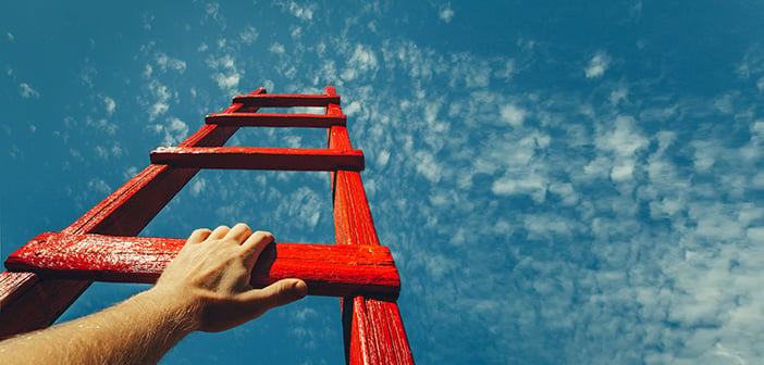 Mans Hand Reaching For Red Ladder Leading To A Blue Sky