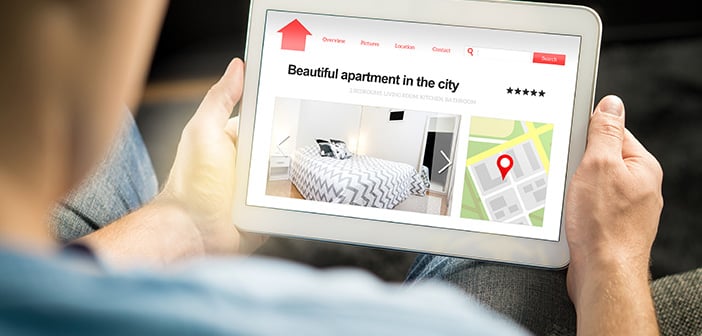 Man search apartments and houses online with mobile device. Holiday home rental or real estate website or application. Imaginary internet marketplace for vacation lodging or finding new home.