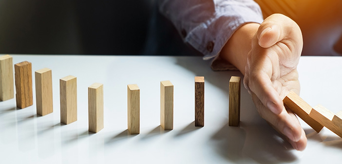 businessman hand stop dominoes continuous toppled, Panoramic composition suitable for banners