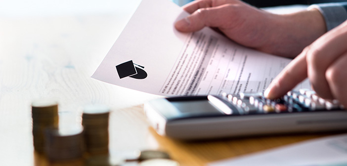 Man counting college savings fund, tuition fee or student loan with calculator. Education price and expenses concept. Money and papers on table. Calculating budget and planning finance.