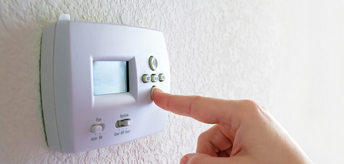 closeup of thermostat and hand