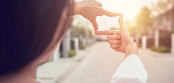 Close up of woman hands making frame gesture with sunlight outdoors