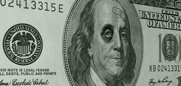 Ben Franklin with sports a shiner (black eye) and a band-aid on the face of a US One Hundred Dollar Bill (C-Note) as an illustration of the weak dollar.