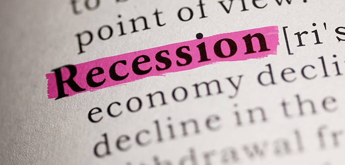 close up of the word recessions highlighted in pink in a dictionary