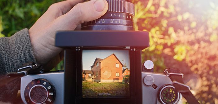 man photographer is making arhitecture photography with old film camera in spring,  home and building concept. top view.