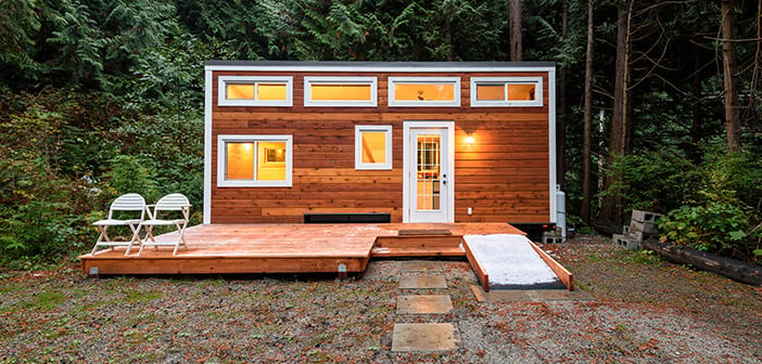 Small wooden cabin house in the evening. Exterior design.