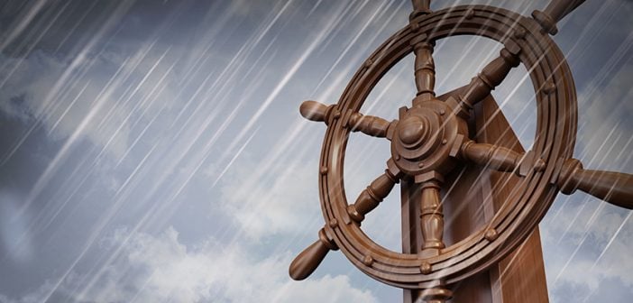 wheel of ship against a dark cloudy sky while raining