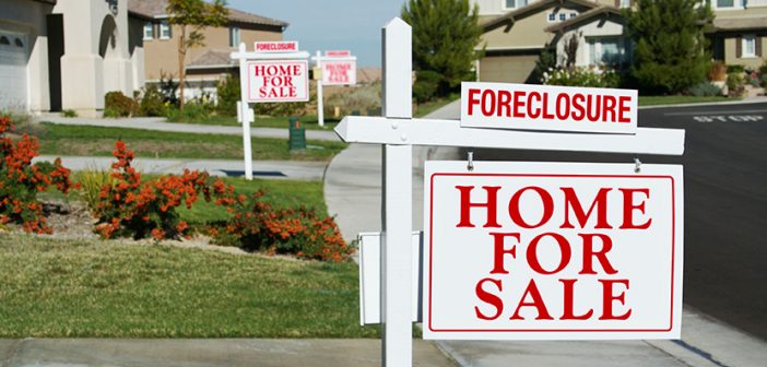 Real Estate Signs in Front of Row Houses of Foreclosure Homes for Sale.