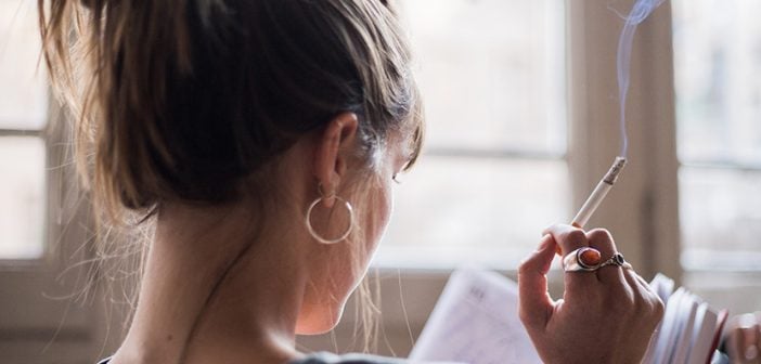 girl smoking while reading