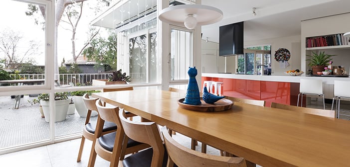 Scandinavian styled dining room and open plan kitchen with patio outlook