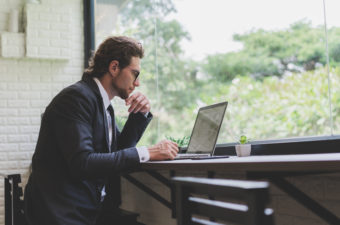 man in suit on laptop looking for dscr loans