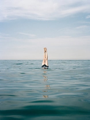 person diving into ocean