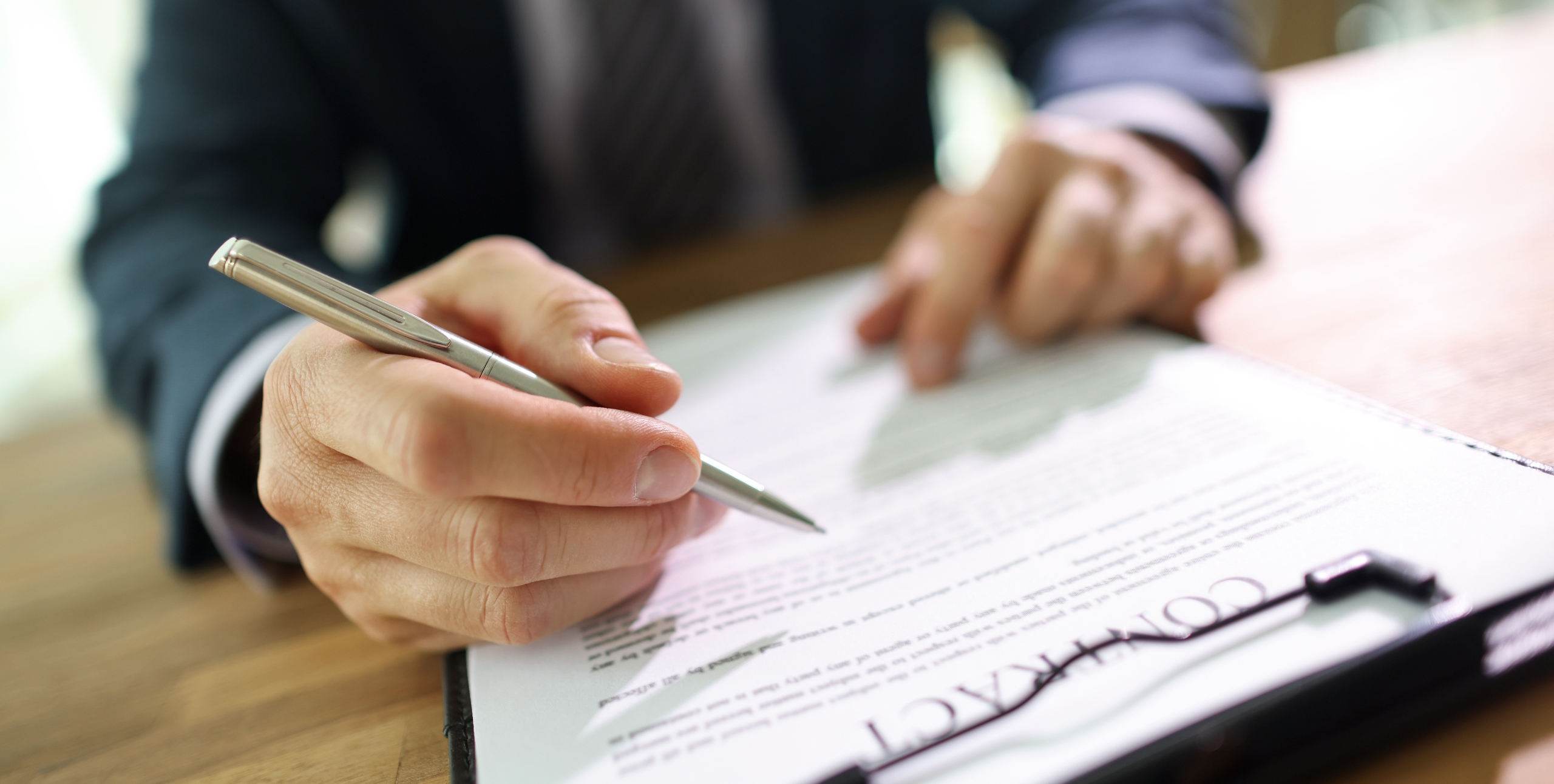 man signing a statement of work for real estate