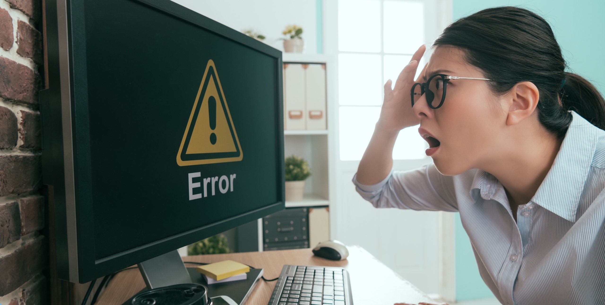 woman looking at error on computer screen