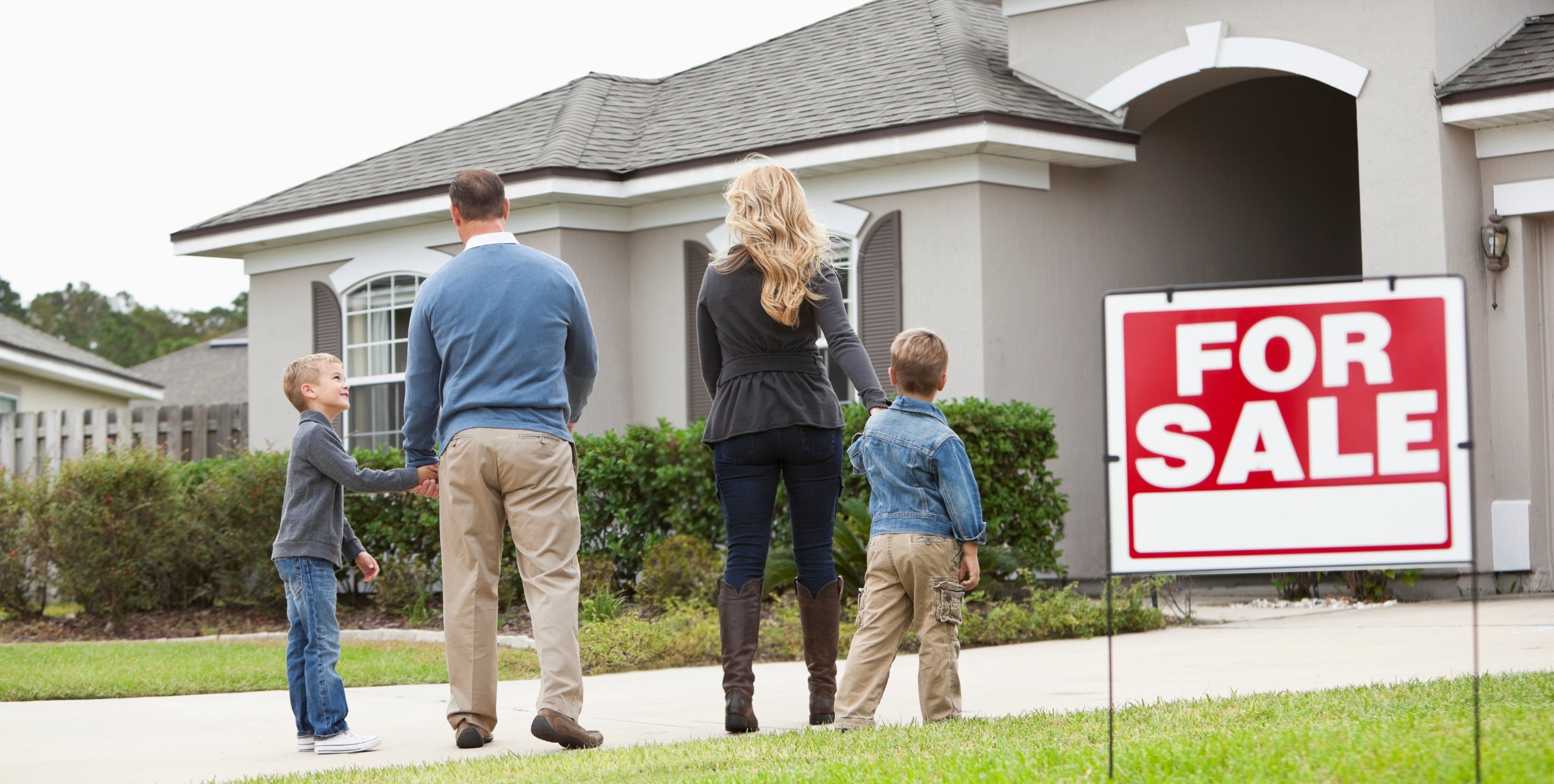 home for sale with family looking at it