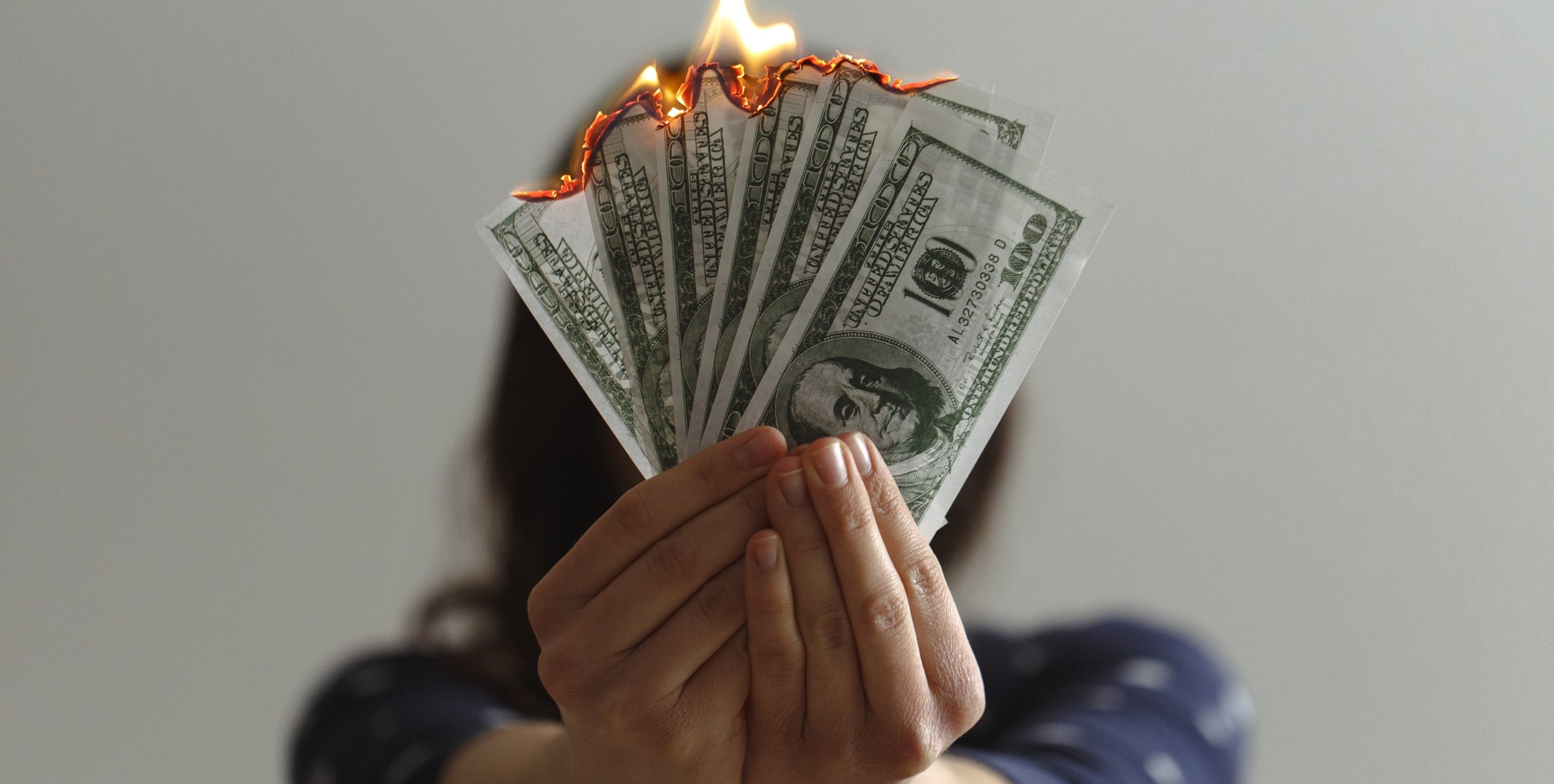 cash burning in hand