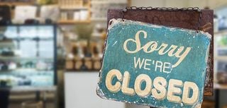 sorry we are closed sign hanging outside a restaurant, store, office or other