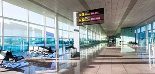 A view of empty hall of hte modern airport, the interior with sun light