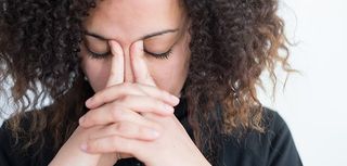 woman with hands on face looking concerned, worried, sad, scared