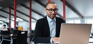 Handsome businessman working and using laptop in the office